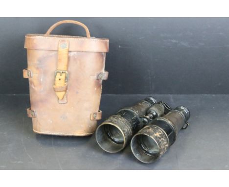 A pair of British Military issued World War One field binoculars, broad arrow marked to the binoculars and leather case, date