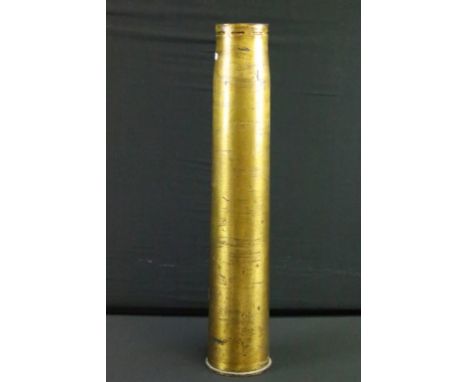 A British military inert brass artillery shell, broad arrow marked to base and dated 1940. 
