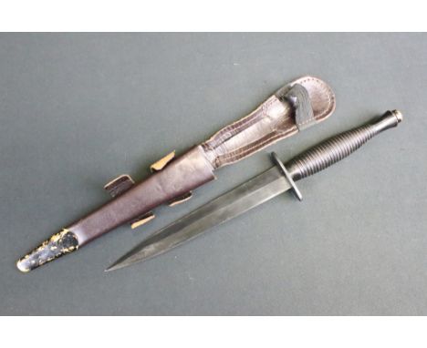 A Fairbairn Sykes commando fighting knife, spearpoint double edge blackened blade measures 17.5cm, blackened oval cross guard