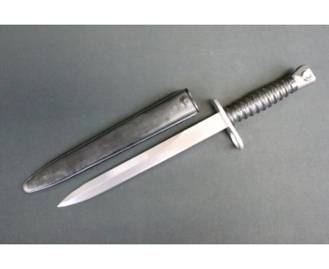 A Swiss SIG M1957 Bayonet, Double edged blade, Steel crossguard ,muzzle ring and pommel. Black composite ribbed grip. Contain