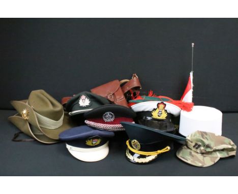 A collection of military caps and hats all complete with associated badges to include Indian Navy, Royal Australian Regiment,
