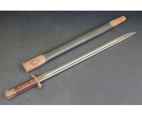 A British Military Issue 1907 pattern SMLE bayonet complete with leather scabbard. 