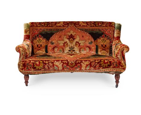 A MID-VICTORIAN WALNUT SOFA CIRCA 1880      The slightly curved back, scrolled arms and incurved seat upholstered in Turkey-w