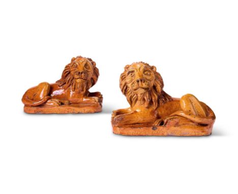 A MATCHED PAIR OF PILL POTTERY (NEWPORT MONMOUTHSHIRE) TREACLE-GLAZED RED POTTERY MODELS OF RECUMBENT LIONS 1850 AND 1860  Mo