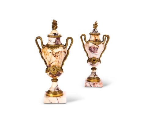 A PAIR OF GILT METAL MOUNTED BRÈCHE VIOLETTE URNS  FRENCH, EARLY 20TH CENTURY  Of shaped ovoid form with entwined serpent han