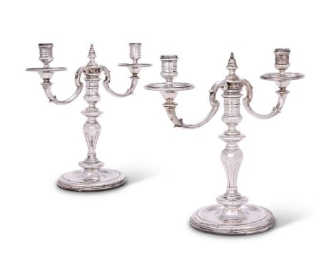 A PAIR OF CONTINENTAL SILVER TWIN LIGHT CANDELABRA  MARKS OBSCURED With reel capitals, circular drip pans, twin scroll arms, 
