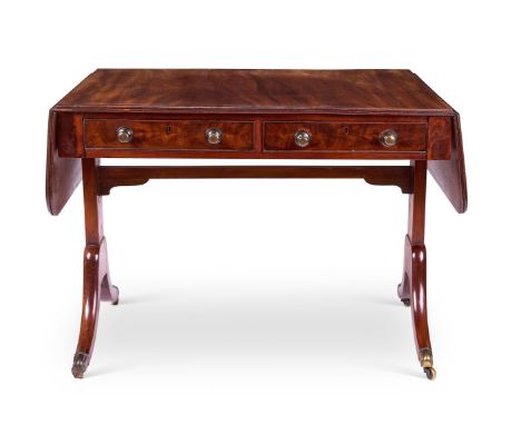 A REGENCY MAHOGANY SOFA TABLE  EARLY 19TH CENTURY    The rounded rectangular twin-flap top above two frieze drawers on standa