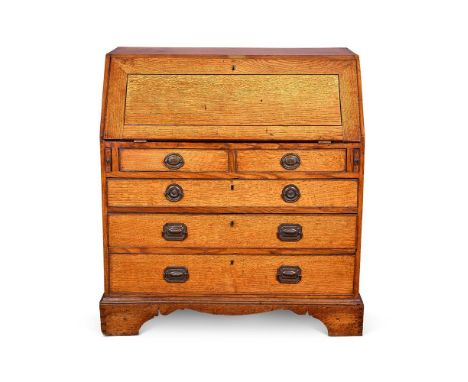 A GEORGE III PALE OAK BUREAU  POSSIBLY ESTATE-MADE, LATE 19TH CENTURY The sloping flap enclosing a fitted interior above two 