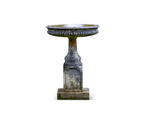 A LARGE RECONSTITUTED STONE BIRDBATH  EARLY 20TH CENTURY  With circular foliate decorated bowl  110cm high, top 80cm diameter