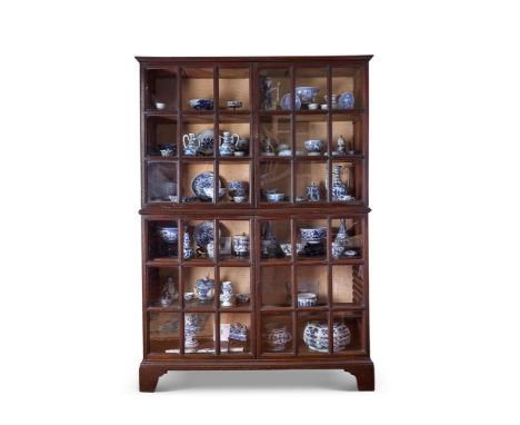 A GEORGE I OAK BOOKCASE EARLY 18TH CENTURY     With a shallow moulded cornice above two pairs of glazed doors, the upper sect