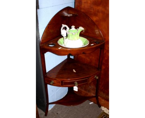 George III period mahogany corner wash stand, fitted upper tier with non-matching china jug and bowl, the lower tier with a c