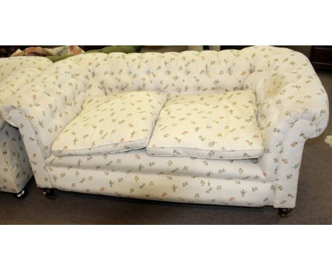 Matched pair of late Victorian Chesterfield sofas both upholstered in matching floral button back (one has a single drop end 