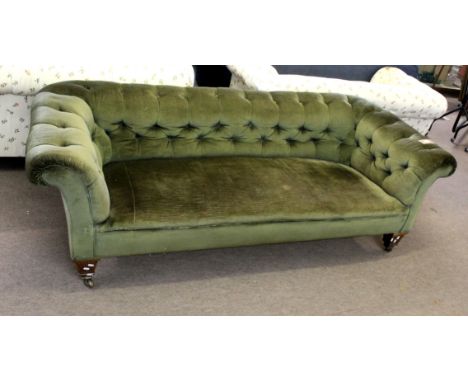 Late 19th century oak framed green button back upholstered Chesterfield, short tapering spade supports terminating in brass c