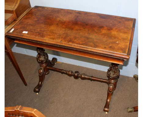 Victorian walnut fold-top card table of rectangular form raised on moulded column supports joined by a similar stretcher with