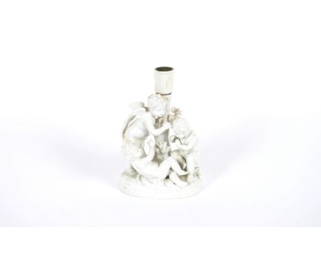 A 19th Century German porcelain blanc de chine candlestick, decorated with cherubs and flowers, 19cm high, AF
