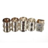 A pair of numbered silver napkin rings, with beaded decoration, London 1889; a square silver