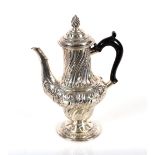 A Victorian silver baluster chocolate pot, with embossed foliate decoration, the domed hinged lid
