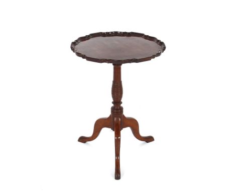 A George III style mahogany occasional table,&nbsp;with pie crust border and tilt top, raised on a ring turned baluster colum