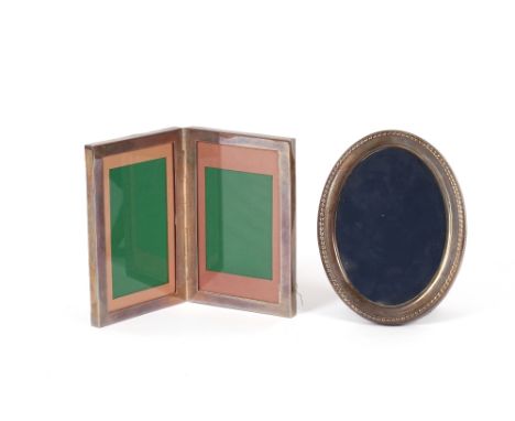 An oval silver mounted easel photograph frame;&nbsp;and a silver and oak folding double photograph frame