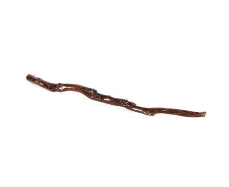 An American Indian Folk Art hardwood walking stick,&nbsp;carved with seven human heads and two animals, 88cm long
