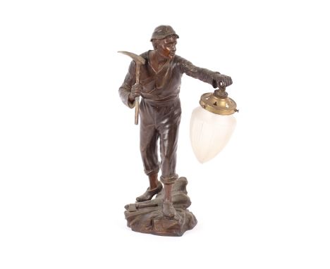 A bronzed table lamp,&nbsp;in the form of a miner with pick axe, 55cm high