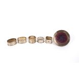 A pair of good quality silver engine turned decorated serviette rings, three others 141.7gms and a