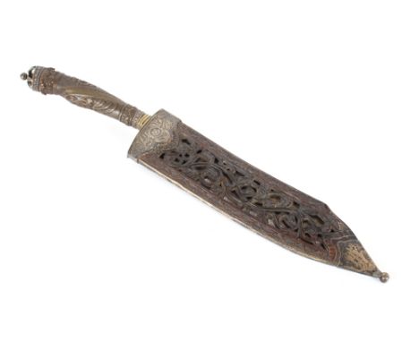 An Ornate Eastern dagger, the curved blade with gilded foliate decoration beneath a brass hilt, the handle and scabbard in ca