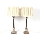 A pair of plated Corinthian column table lamps, complete with pleated silk shades 74cm high