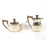 A silver tea pot, of octagonal form, having stylised border decoration, wooden handle and lift,