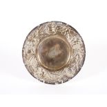 An Edwardian circular silver foliate embossed stand, London 1905; 24cm dia., 348gms