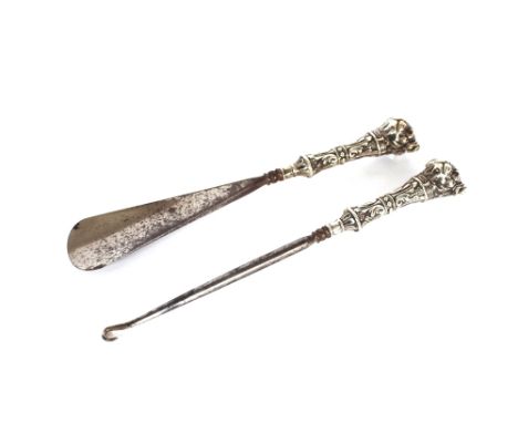 A novelty shoe horn and button hook,&nbsp;with Hallmarked silver handles, dog head terminals,&nbsp;Birmingham 1908,&nbsp;the 