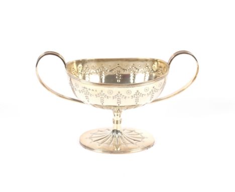 A Victorian silver pedestal sugar basin, with reeded scroll handles, embossed floral and garland decoration on an out swept c