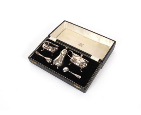 A cased silver three piece cruet, by Adie Bros., Birmingham 1958,&nbsp;having odd silver and plated condiment spoons, 115.7gm