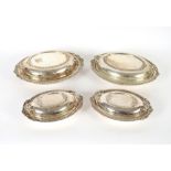 Two pairs of graduated plated entreé dishes, with shell and gadroon decorated borders and two