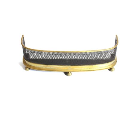 A Victorian brass and wire work D shaped fender, raised on ball feet, 88cm wide&nbsp;