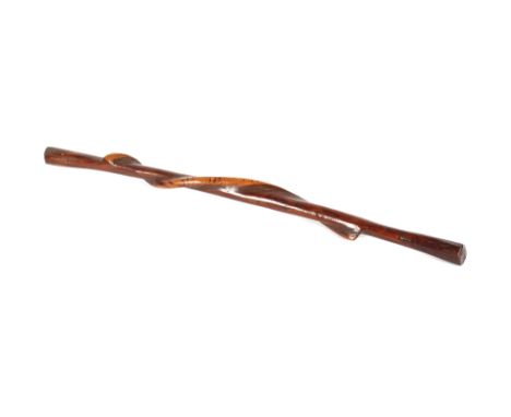 A hardwood stick,&nbsp;with snake climbing up the shaft, singed decoration to the snake, 92cm long