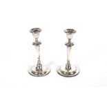 A pair of silver candlesticks, with reeded decoration, loaded bases, Sheffield 1908, 22cm high AF