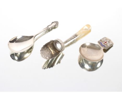 A late Victorian silver caddy spoon, in the form of a coal scoop with foliate decoration and mother of pearl handle; a silver