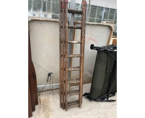 A THREE SECTION WOODEN LADDER 