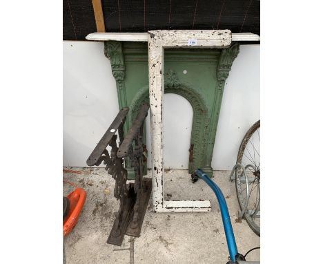 A VINTAGE ORNATE CAST IRON FIRE PLACE AND BENCH ENDS AND A FIRE HEARTH SURROUND 