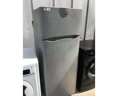 AN INDESIT UPRIGHT FRIDGE FREEZER, SHELF MISSING, DOOR COMPARTMENT MISSING, NEEDS A CLEAN 