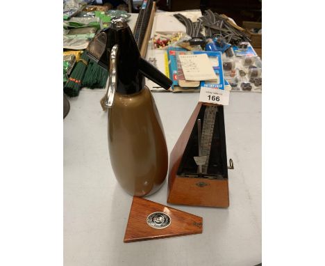 A VINTAGE SODA SYPHON AND METRONOME 
