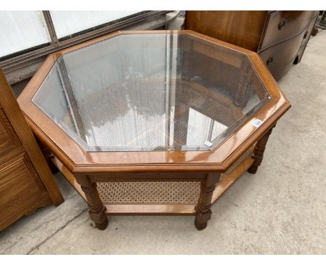 AN OCTAGONAL MAHOGANY COFFEE TABLE WITH GLASS TOP AND LOWER SHELF 