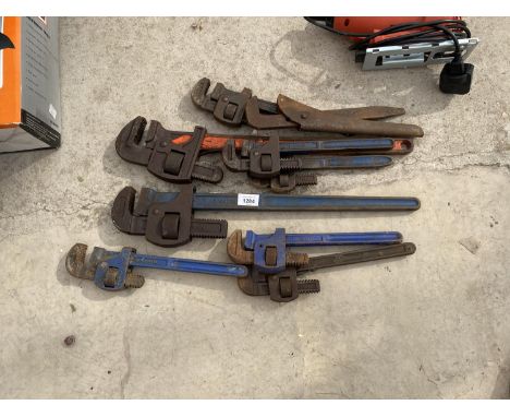 SEVEN STILSONS AND AN ADJUSTABLE SPANNER 