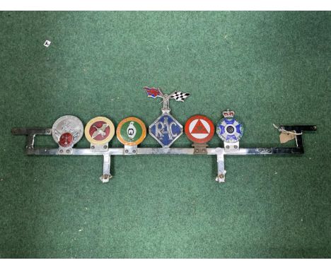 SIX VINTAGE CAR BADGES ON A CHROME FRAME TO INCLUDE WAGBI, RAC, INSTITUTE OF ADVANCED MOTORISTS ETC 