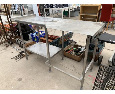 A LONG STAINLESS STEEL TABLE WITH LOWER SHELF 