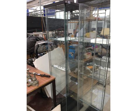 A THREE SHELF GLASS DISPLAY CABINET