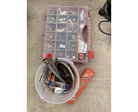A LARGE QUANTITY OF PLUMBING SPARES IN A CASE AND A BASIN WRENCH 