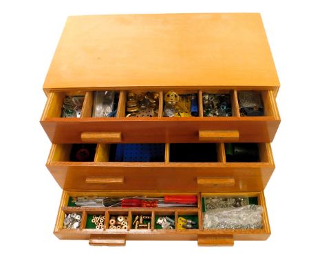 A wooden box containing Meccano gears, chains, tools, etc. 