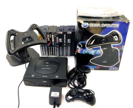 A Sega Saturn console, games and accessories, including Sega Saturn steering wheel, controllers, Fifa Road to World Cup, Nasc